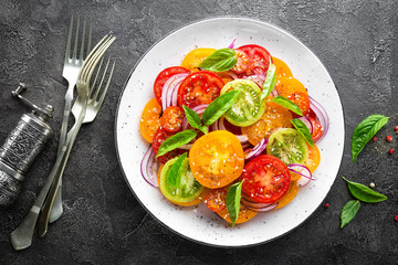 Tomato salad. Fresh vegetable salad with tomatoes, onion and basil