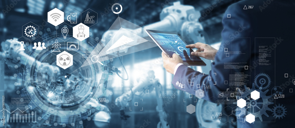 Fototapete Technician manager, Industrial engineer controlling roboticts on monitoring system software and icon industry network connection on tablet. AI Automation robot arm machine in smart factory.