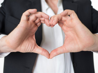 Business man make heart shape with his hand.