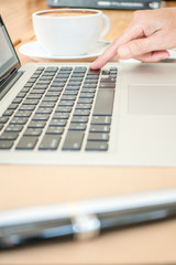 Business woman press on keyboard laptop at office desk. Selective focus.