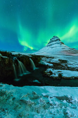 Aurora Borealis or northern light above kirkjufell mountain in iceland