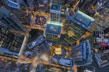 Schilderijen op glas Modern architecture buildings at night aerial view located in the heart of the financial centre © PRADEEP RAJA