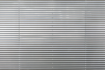 Metal Wall with Structure / Close-up of streamlined clean and shiny grey metallic background (copy space)