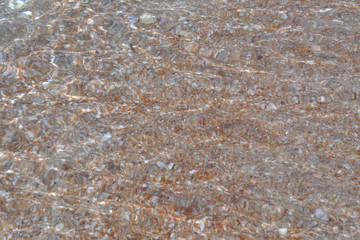 Tide waves on the beach with shells and sand