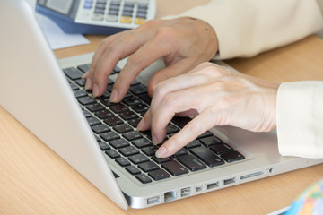 Business woman working with laptop at business office. Selective focus.