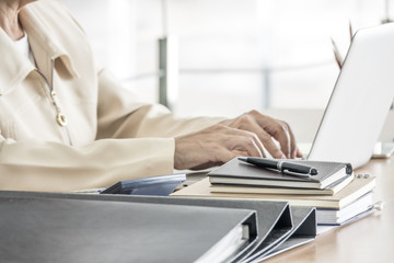 Business woman working with laptop at business office. Selective focus.