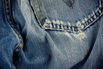 brown seam denim  and old blue jeans denim texture close up
