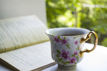 A cup of tea and a book.