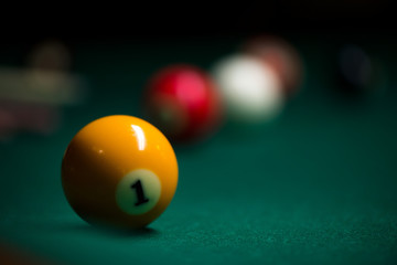 Sport billiard balls on green billiard table in pub. On going billiard game. Competitive players trying to find out the winner of the round