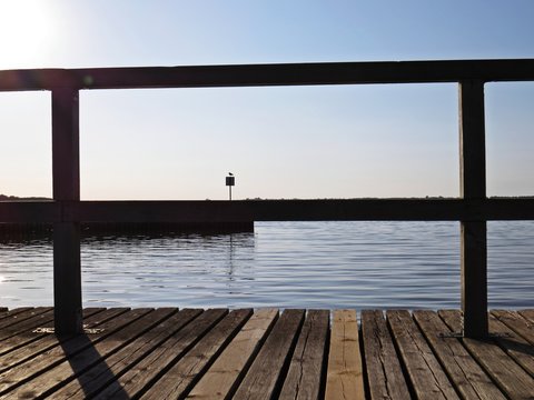 Wharf Catwalk During Sunset Over Beautiful Lake with Cloudy Sky in background
