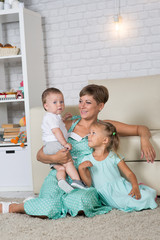 mom with two children playing at home in the room