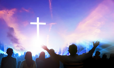 Worship and praise concept: Silhouette many people raised hands over sunset background - obrazy, fototapety, plakaty