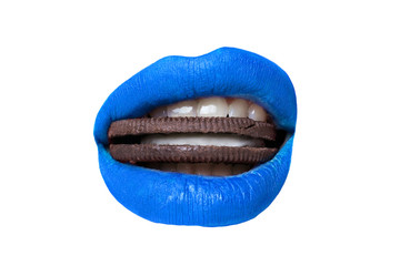 Female lips with blue lipstick bites cookies on white background closeup