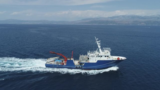 Aerial shot of fishing boat cruising at sea - July 2018: Adriatic sea, Croatia