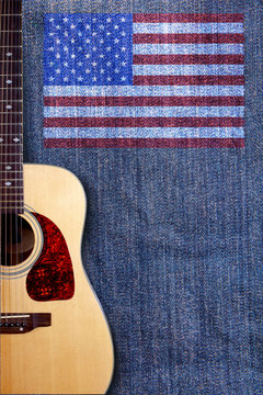 Acoustic guitar and American flag on a background of denim
