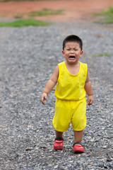 Fototapeta premium boy in yellow dress is crying