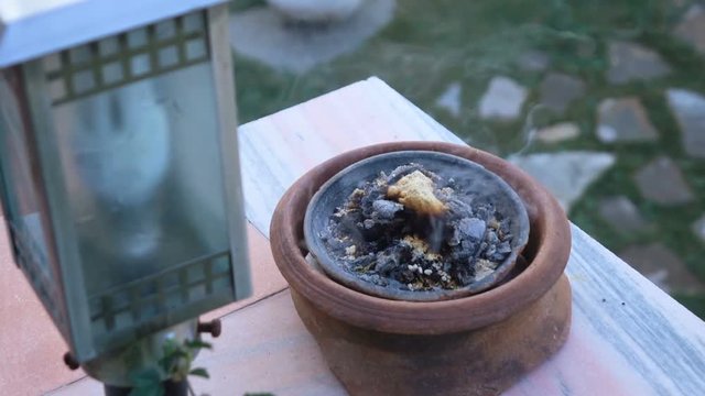 Frankincense burning on a hot coal. Frankincense is an aromatic resin, used for religious rites