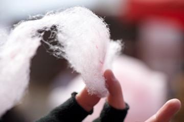 Selling cotton candy. Picking and holding pink cotton candy at a local state fair. Concept of...