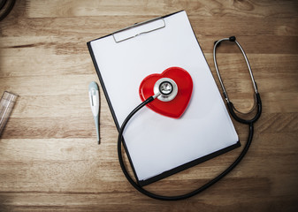 medical stethoscope check heart on wooden table.