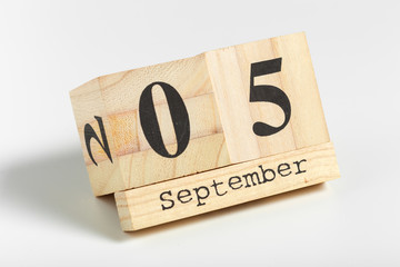 Wooden cubes with date on white background. 5th of September