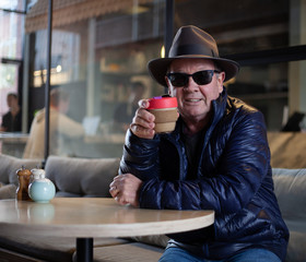 Man with a yellow coffee cup 