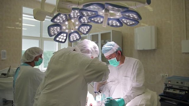 The surgical team of the hospital conducts an oncological operation using innovative surgical instruments