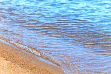 Blue clear water. Sea, lake, sun, beach, vacation Background for inserting images and text. Tourism, travel.