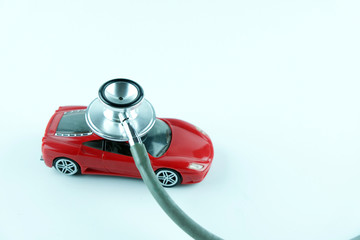 Stethoscope checking up the car on white background, Concept of car check up, repair and maintenance..