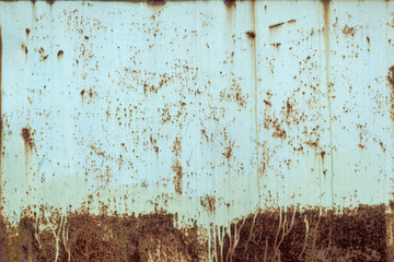Close-up of a yellow old battered steel mill. Metal rusty texture