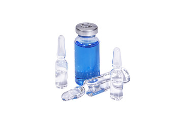 Medical vial with blue vaccine and ampoules on white background.