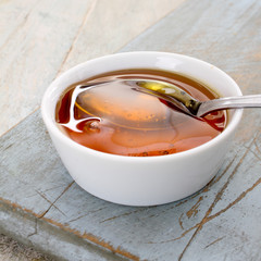 refined golden sugar syrup in dish