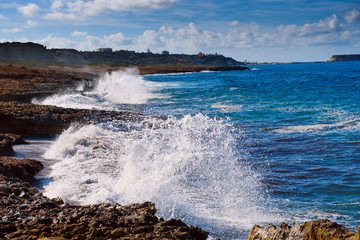 Sea wave splashing on rocks, natural holiday vintage hipster seasonal background