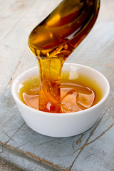 refined golden sugar syrup in dish