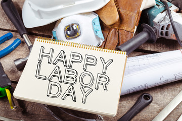 Labor day. Different tools on wooden background .