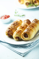 Homemade sausage rolls with sesame seeds