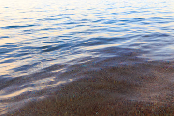 Blue clear water. Sea, lake, sun, beach, vacation Background for inserting images and text. Tourism, travel.