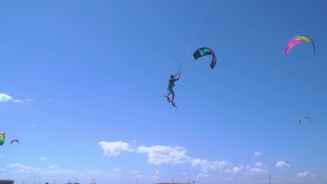 UKRAINE, GENICHESK - AUGUST 11, 2018:Slow-motion shooting, male kiter flies into the air