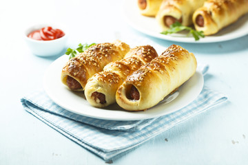 Homemade sausage rolls with sesame seeds