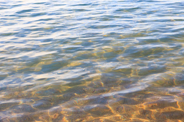 Blue clear water. Sea, lake, sun, beach, vacation Background for inserting images and text. Tourism, travel.