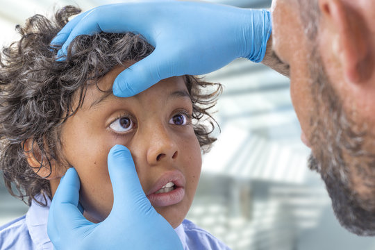 ophthalmology. eyes exam, male doctor examining teen patien teyes