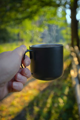 Man hand drinking coffee in morning