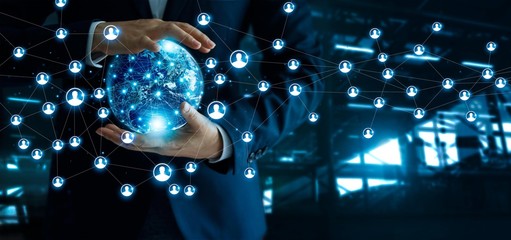 Businessman holding global customer network connection in hands.Technology  and structure networking and data exchanges communication on dark blue background. 