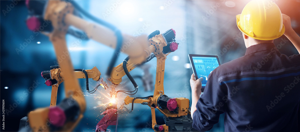 Aufkleber Engineer check and control welding robotics automatic arms machine in intelligent factory automotive industrial with monitoring system software. Digital manufacturing operation. Industry 4.0
