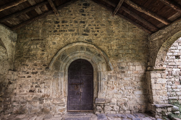 Fototapeta na wymiar Ancient wooden door of Sant Feliu church in Barruera, Catalonia, Spain.