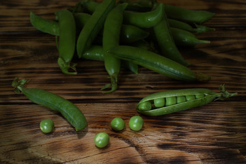 Sweet green peas in pods on the table