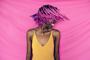 Girl shaking her pink braided hair - obrazy, fototapety, plakaty