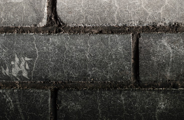 Brick wall covered with black soot