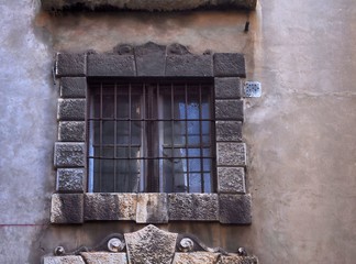 Baroque stone window on ancient building facade,