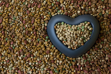 Heart bowl filled by dry pet food