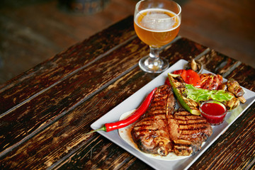 Steak And Beer. Barbecue Meat With Grill Vegetables And Beer